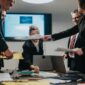 business professionals collaborating corporate meeting documents technology group business professionals 371376850 85x85